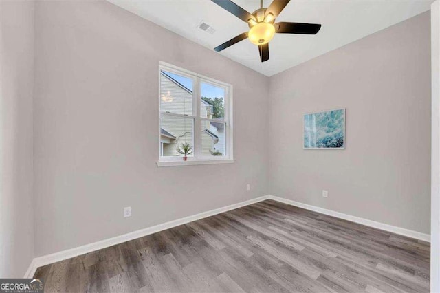 empty room with ceiling fan and hardwood / wood-style floors