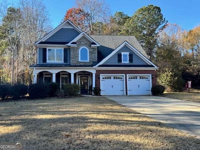 craftsman-style house featuring a front lawn and a garage