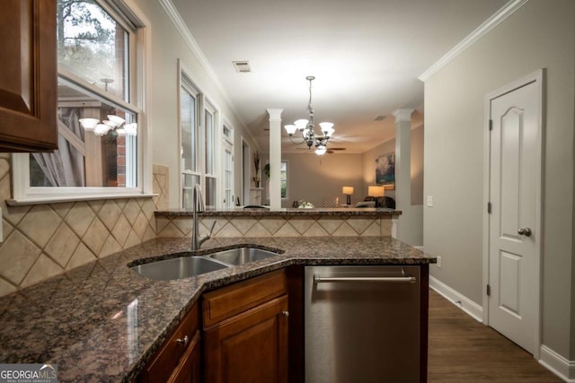 kitchen featuring decorative backsplash, ornate columns, crown molding, and sink