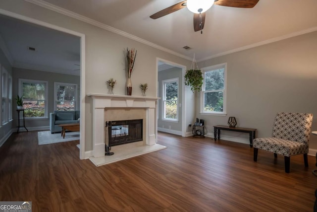 unfurnished room with crown molding, ceiling fan, a premium fireplace, and dark hardwood / wood-style floors