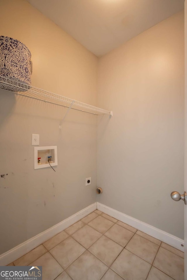 laundry area featuring electric dryer hookup, tile patterned flooring, and washer hookup