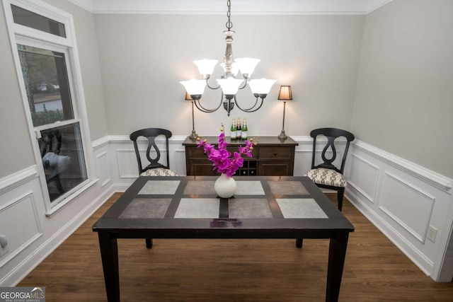 dining area featuring a notable chandelier, dark hardwood / wood-style floors, and ornamental molding