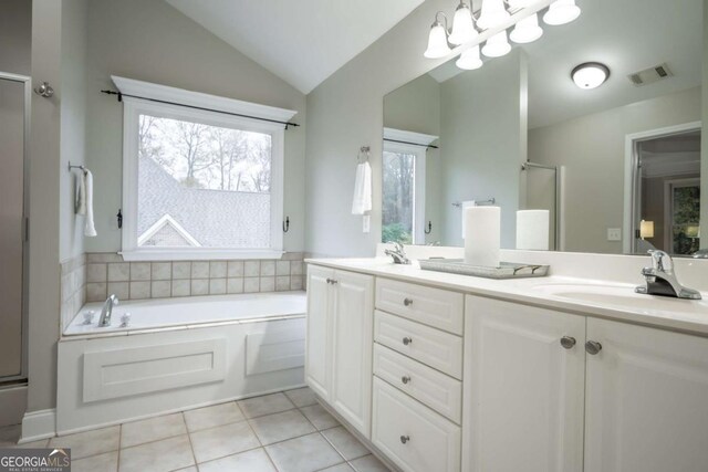 bathroom featuring tile patterned floors, vanity, independent shower and bath, and lofted ceiling