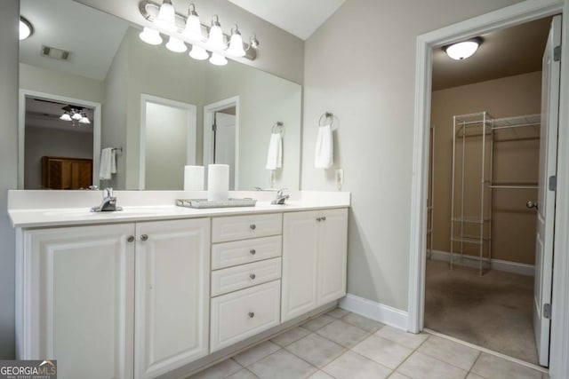 bathroom with ceiling fan, tile patterned flooring, and vanity