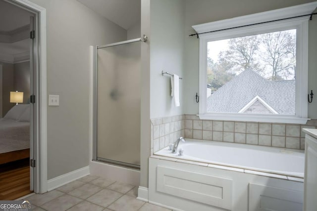 bathroom featuring tile patterned floors, separate shower and tub, and vanity