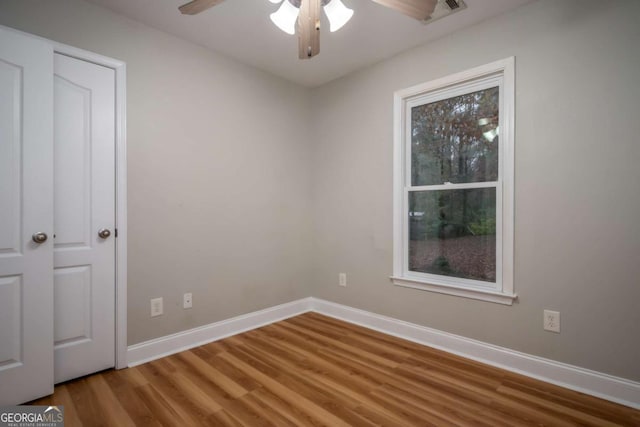 spare room featuring ceiling fan and wood-type flooring