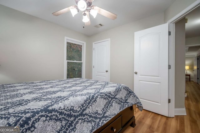 bedroom with ceiling fan and wood-type flooring