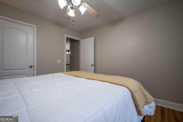 bedroom featuring ceiling fan and dark wood-type flooring