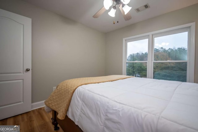 bedroom featuring ceiling fan and dark hardwood / wood-style floors