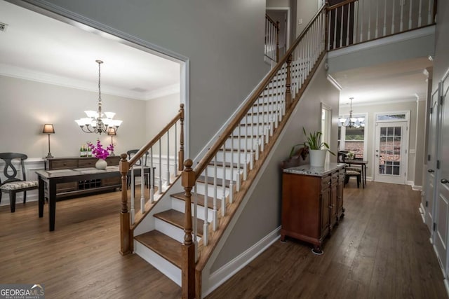 stairs featuring a chandelier, hardwood / wood-style flooring, and ornamental molding