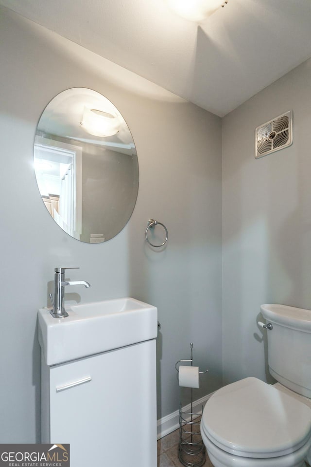 bathroom with vanity, tile patterned flooring, and toilet