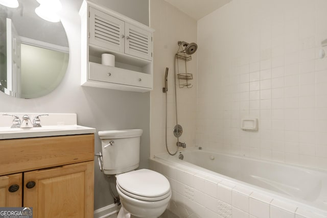 full bathroom with vanity, tiled shower / bath, and toilet