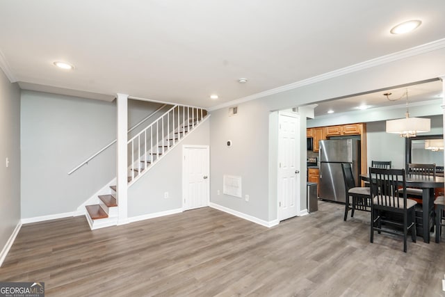 interior space featuring crown molding and hardwood / wood-style floors