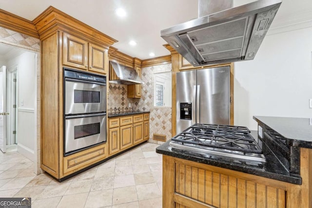 kitchen featuring crown molding, ventilation hood, dark stone countertops, appliances with stainless steel finishes, and wall chimney range hood