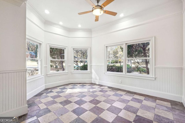 unfurnished sunroom with ceiling fan