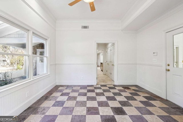 empty room with crown molding and ceiling fan