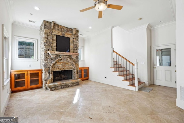 unfurnished living room with ceiling fan, ornamental molding, and a fireplace