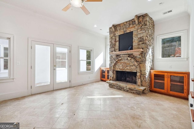 unfurnished living room with ceiling fan, a fireplace, ornamental molding, light tile patterned flooring, and french doors