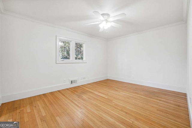 empty room with crown molding, ceiling fan, and light wood-type flooring