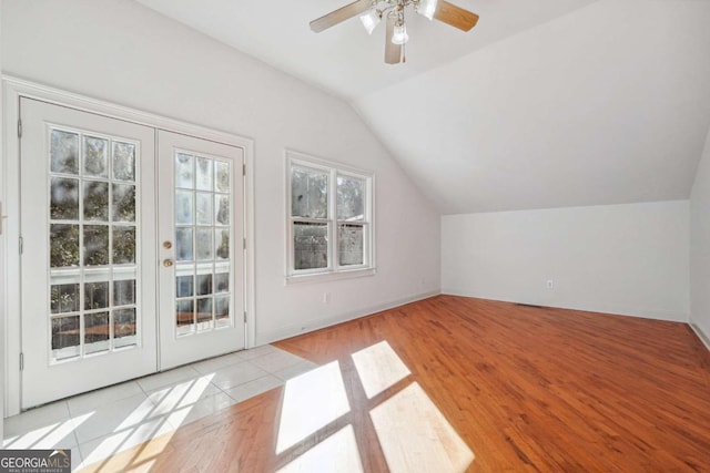 bonus room with light hardwood / wood-style flooring, vaulted ceiling, french doors, and ceiling fan