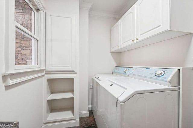 laundry room with cabinets, ornamental molding, and separate washer and dryer