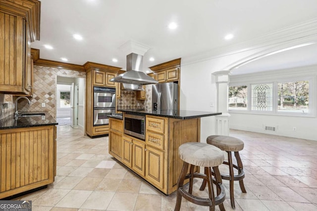 kitchen featuring sink, a kitchen island, stainless steel appliances, ornamental molding, and island exhaust hood