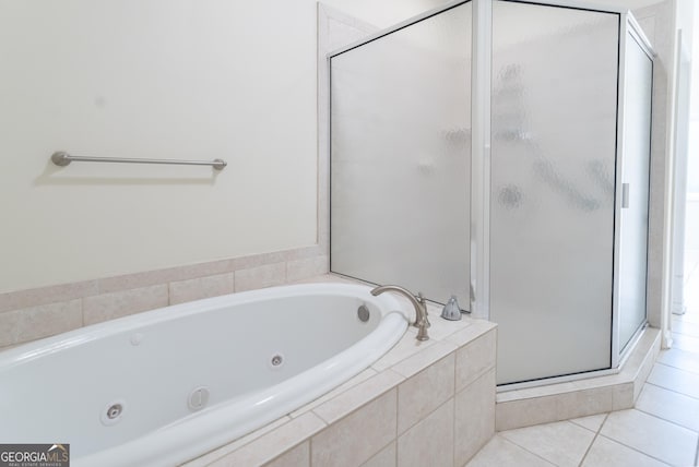 bathroom with tile patterned floors and shower with separate bathtub