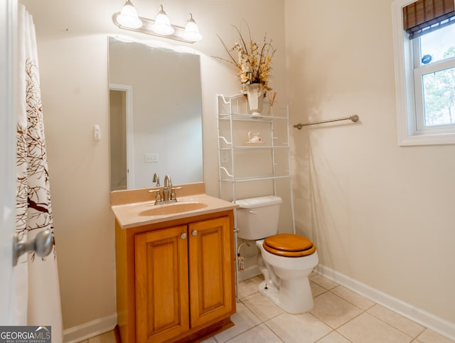 bathroom featuring tile patterned flooring, vanity, and toilet