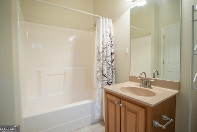 bathroom featuring tile patterned flooring, vanity, and shower / bath combo with shower curtain