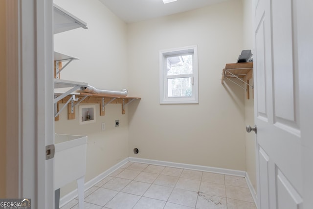 laundry area featuring washer hookup, electric dryer hookup, and light tile patterned floors