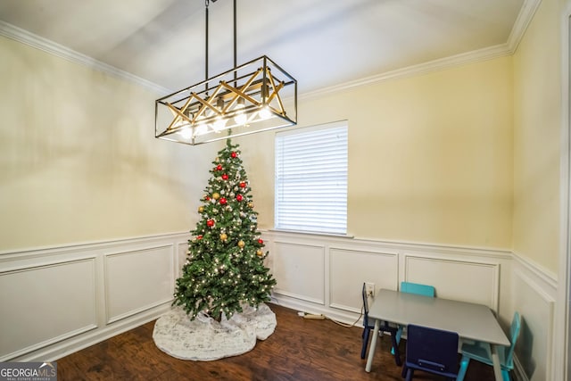 dining room with dark hardwood / wood-style flooring and ornamental molding