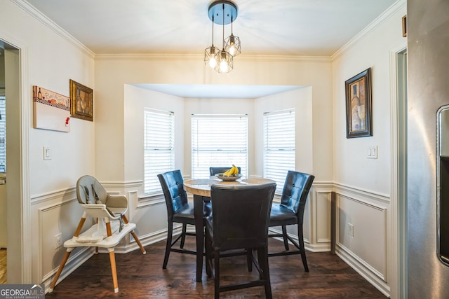 dining space with dark hardwood / wood-style flooring, a chandelier, and ornamental molding