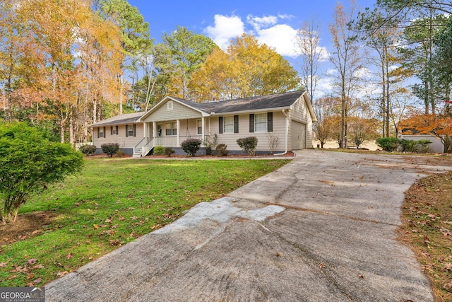 single story home featuring a front yard, a porch, and a garage