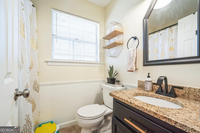 bathroom featuring vanity and toilet