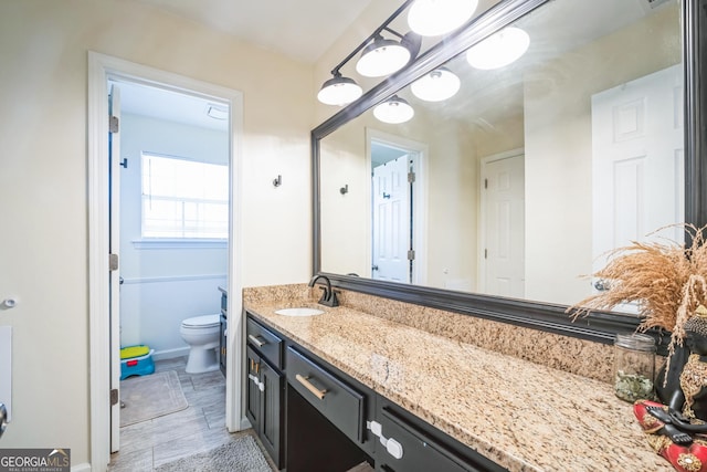 bathroom with vanity and toilet