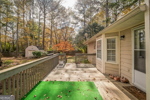 wooden terrace featuring a shed and a yard