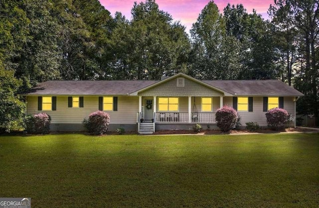 ranch-style house with a yard and a porch