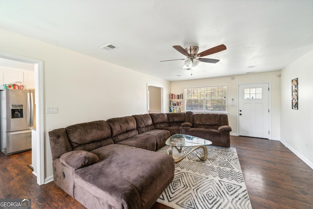 living room with ceiling fan and dark wood-type flooring