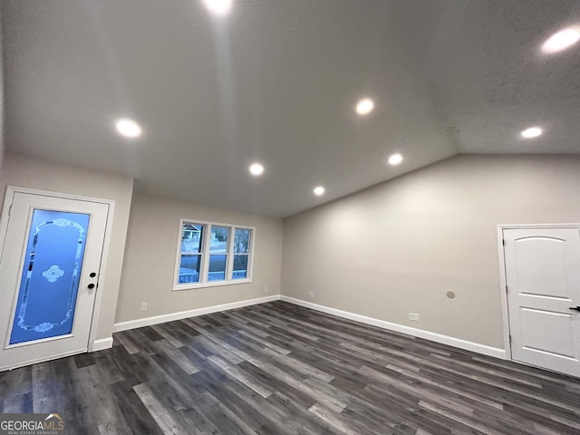 interior space with dark hardwood / wood-style flooring and lofted ceiling