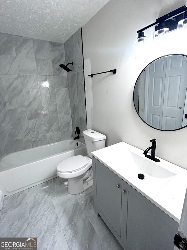 full bathroom featuring vanity, a textured ceiling, toilet, and tiled shower / bath