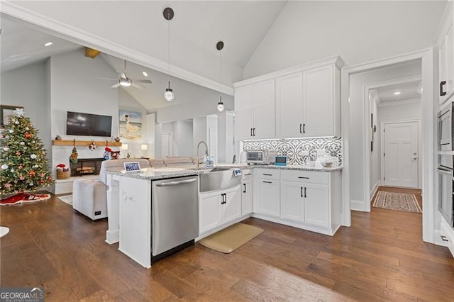 kitchen with ceiling fan, high vaulted ceiling, dark hardwood / wood-style floors, white cabinets, and appliances with stainless steel finishes