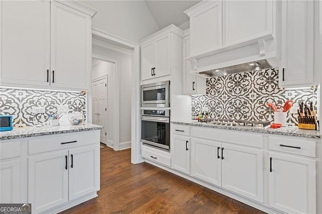 kitchen with stainless steel appliances, dark hardwood / wood-style floors, backsplash, white cabinets, and custom exhaust hood