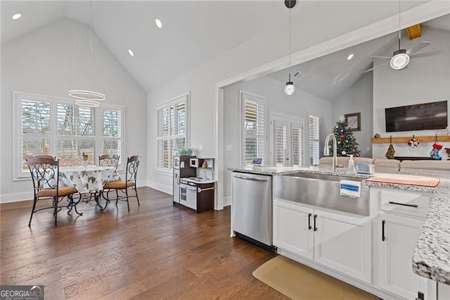 kitchen with stainless steel dishwasher, decorative light fixtures, and white cabinets