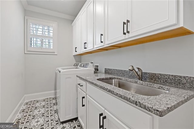 washroom with separate washer and dryer, sink, light tile patterned flooring, and cabinets