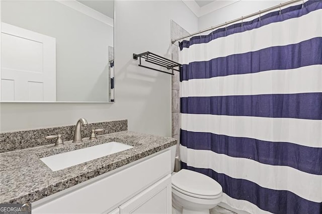 bathroom with curtained shower, vanity, and toilet