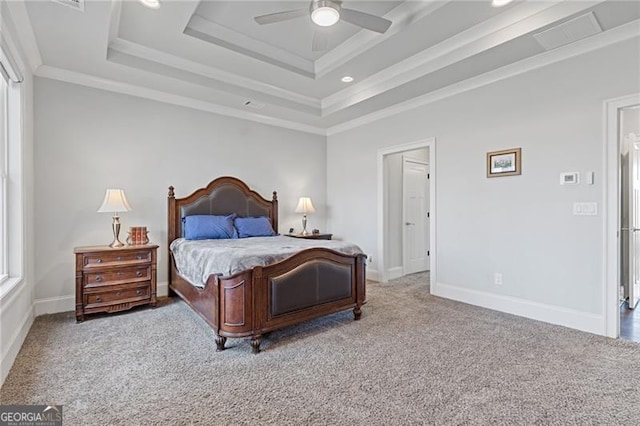 bedroom featuring ceiling fan, a raised ceiling, and light carpet