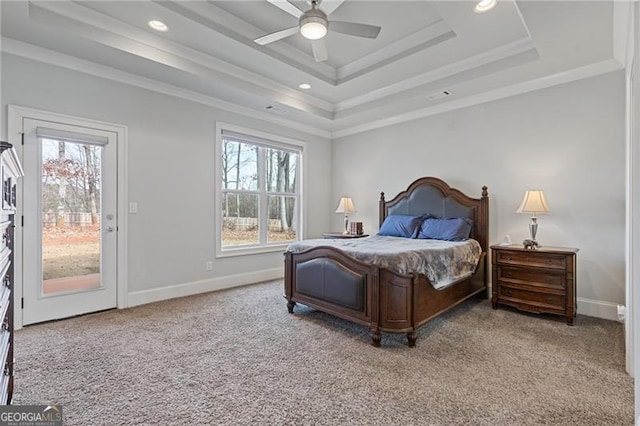 bedroom with a raised ceiling, multiple windows, ceiling fan, and access to outside