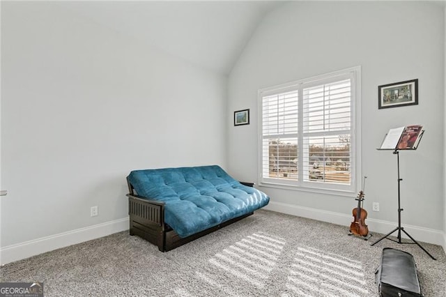 sitting room with carpet floors and vaulted ceiling