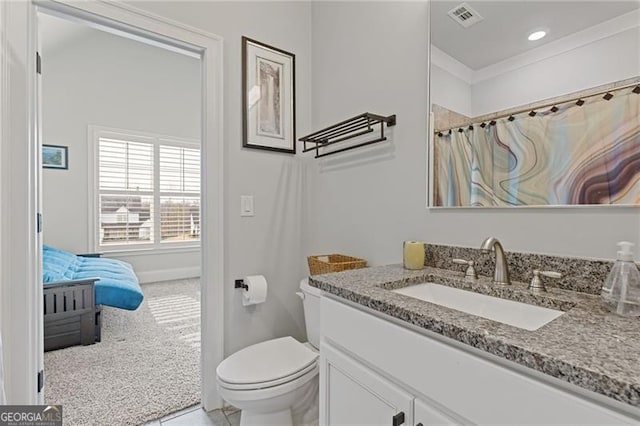 bathroom featuring vanity, toilet, and crown molding