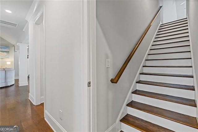 stairs featuring hardwood / wood-style flooring